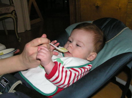 Andres tasting some fruit puree at age 6 months